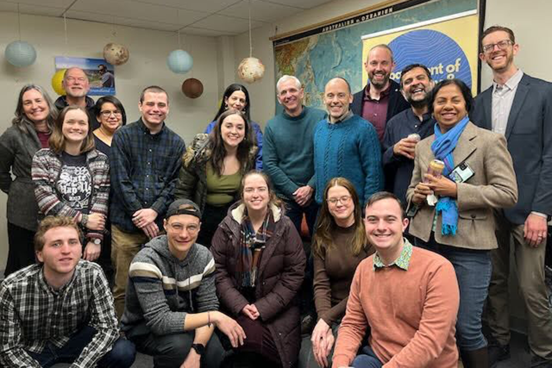 A group of Geography Department faculty and students smiling