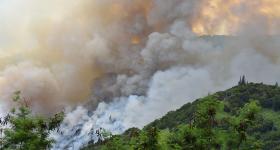 Image of wildfire smoke covering a mountain in Maui